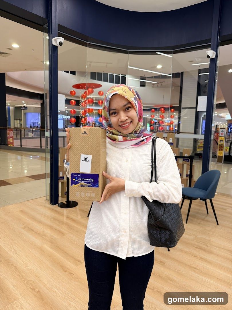 Woman holding product box in shopping mall