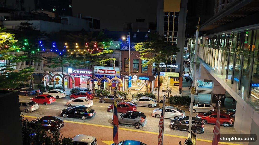 Nighttime street scene with cars and shops