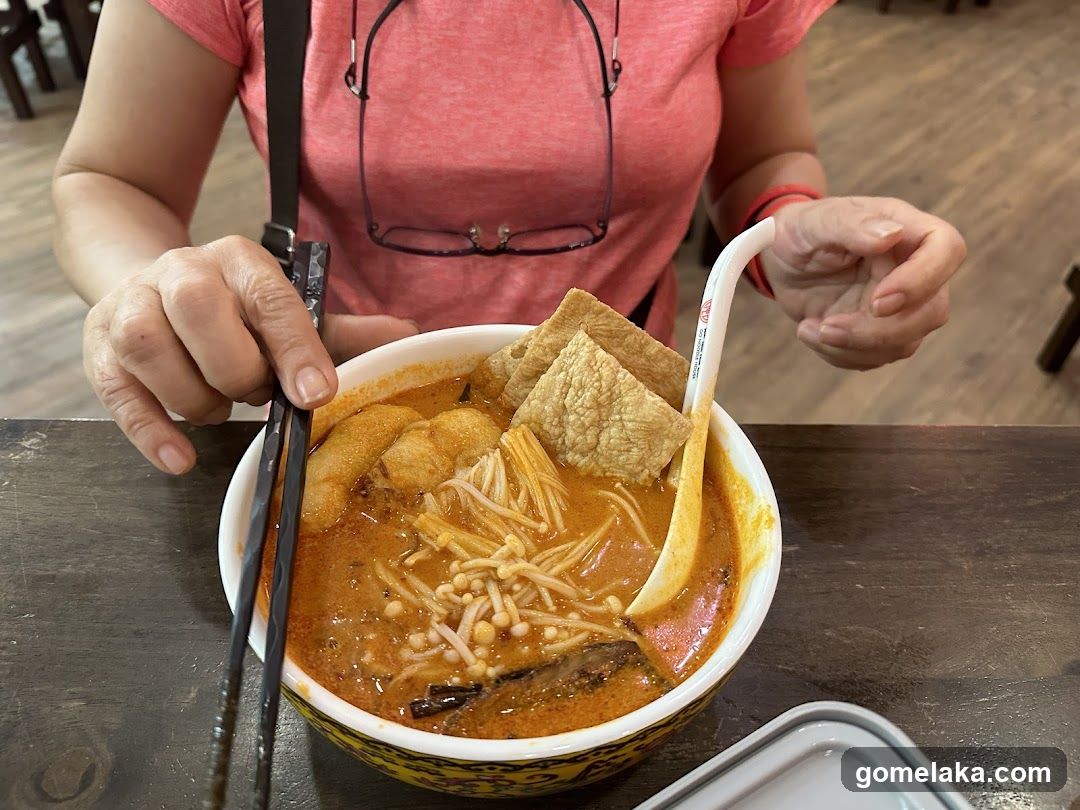 Person eating noodle soup