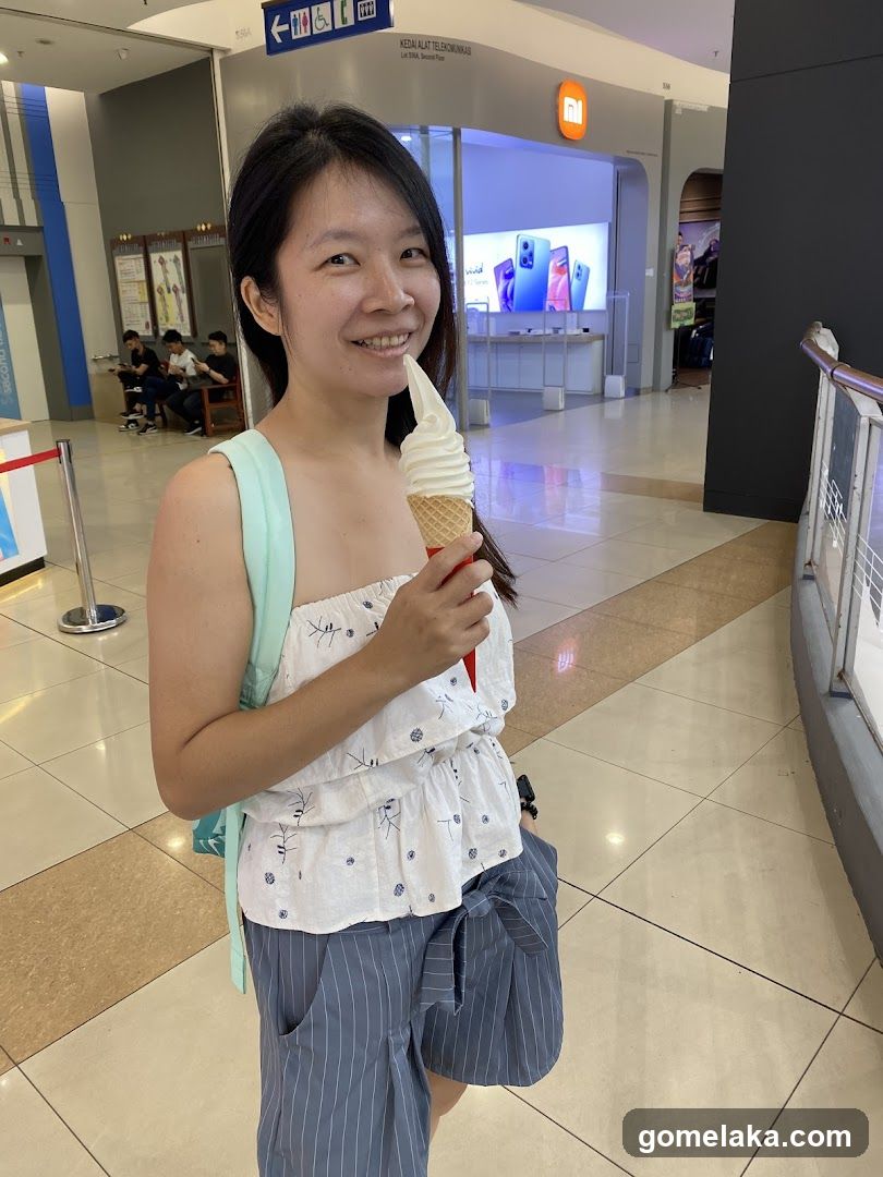 Woman in shopping mall holding ice cream