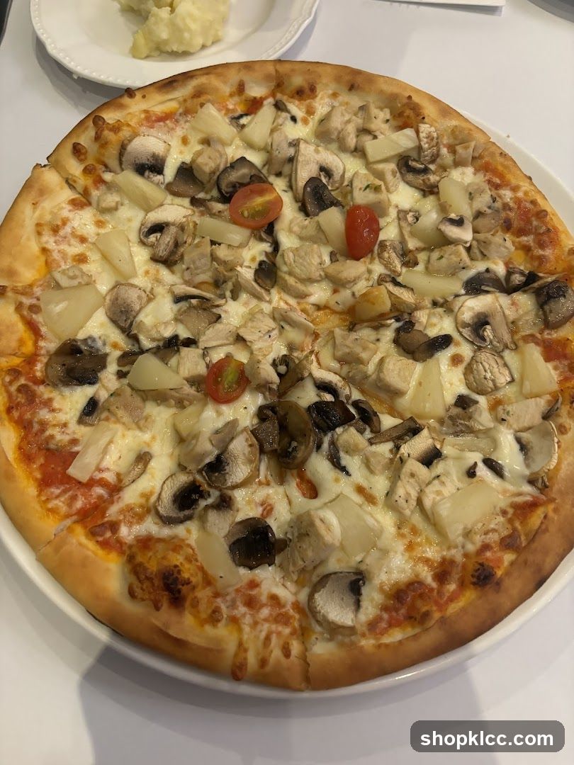 Pizza with mushrooms, pineapple and chicken