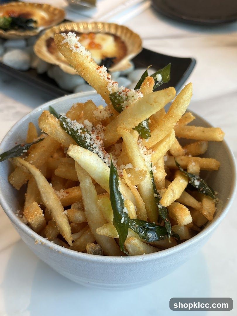 Fries with garnish and scallops in background