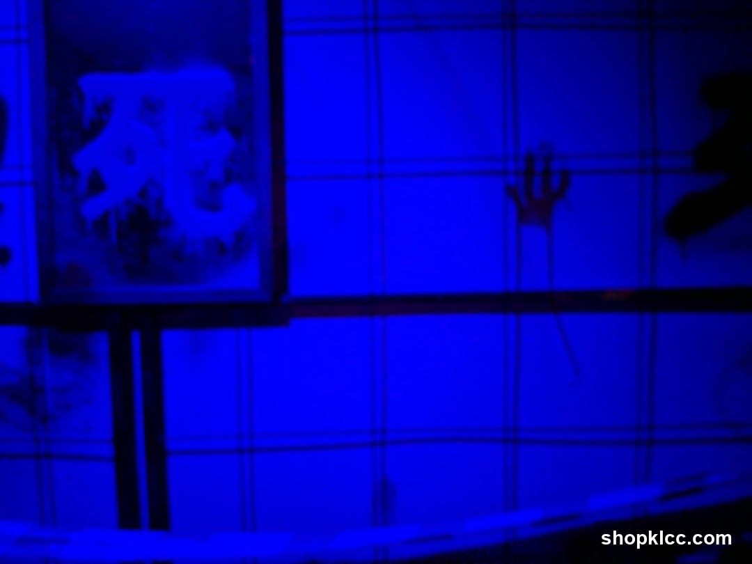 Blue-lit wall with graffiti and handprint