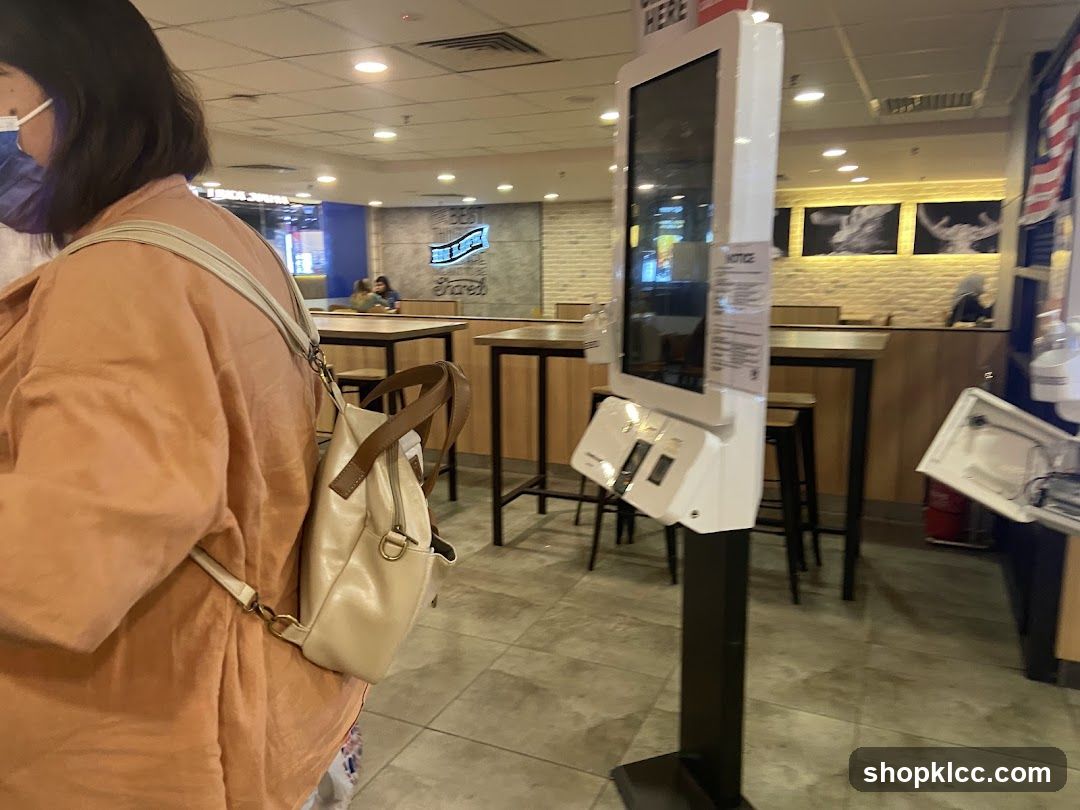 Interior of a food outlet with self-checkout kiosk