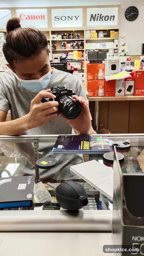 Person examining camera in electronics store