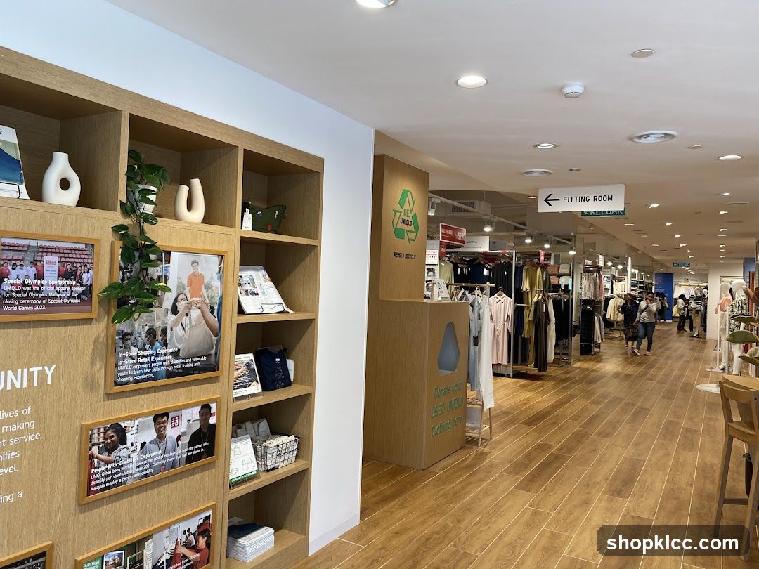 Interior of a clothing store with display shelves and fitting room sign