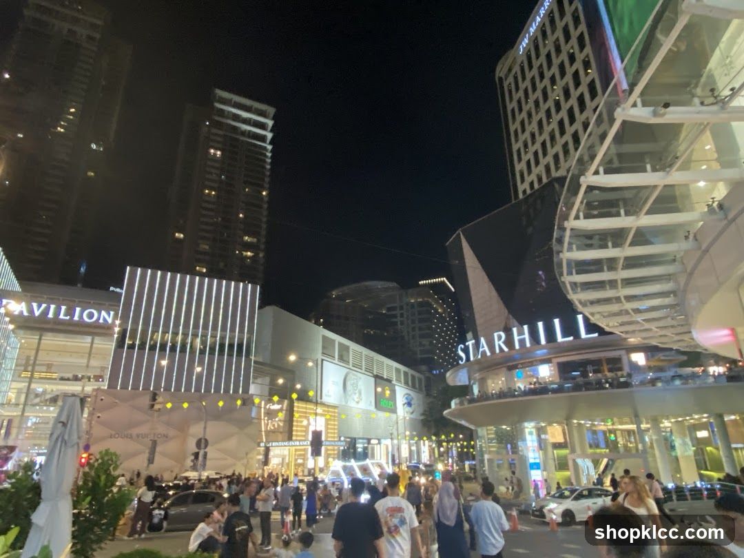 Night scene of shopping area with illuminated buildings and crowds