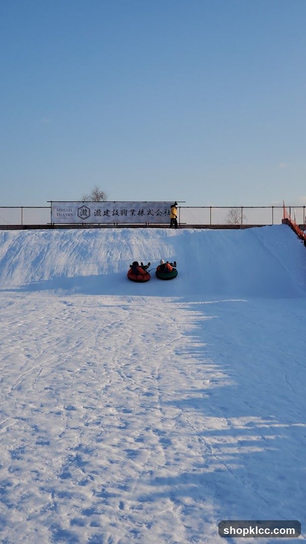 Snow tubing scene with signboard