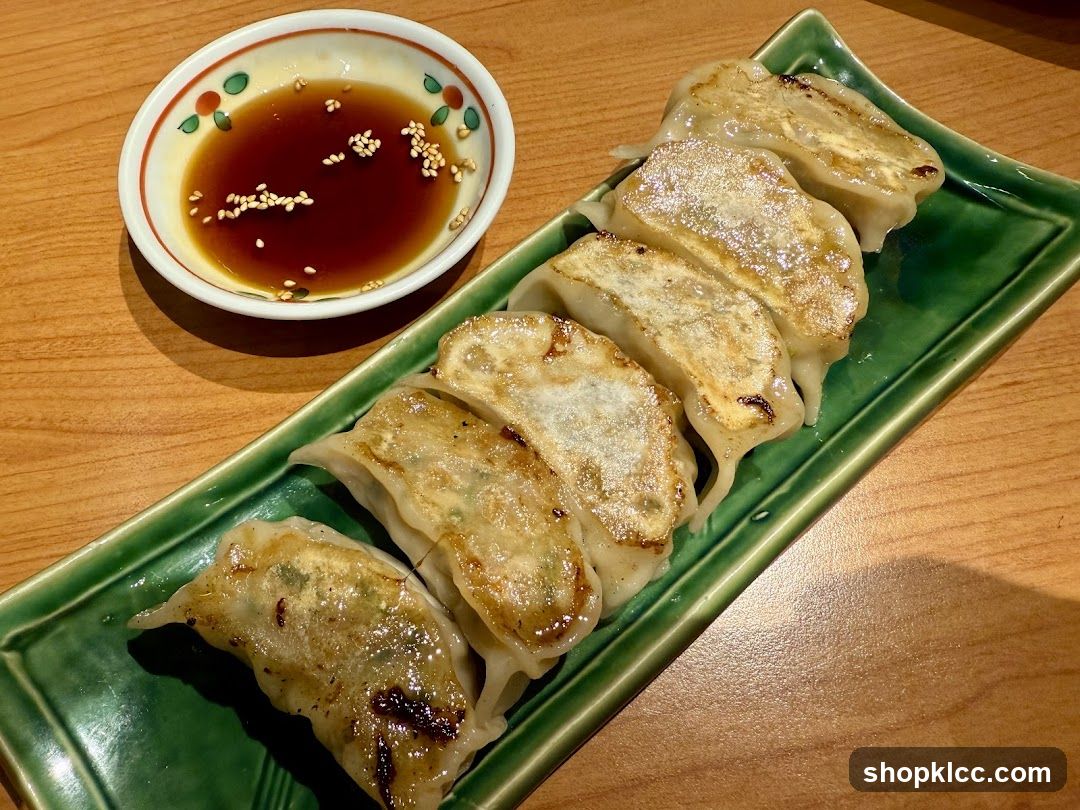 Pan-fried dumplings with dipping sauce