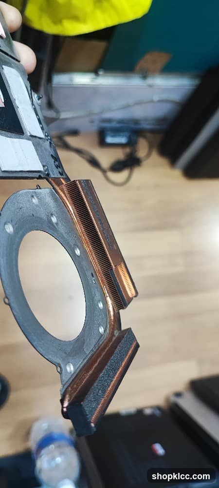 Close-up of a computer component with copper heat pipes and thermal pad