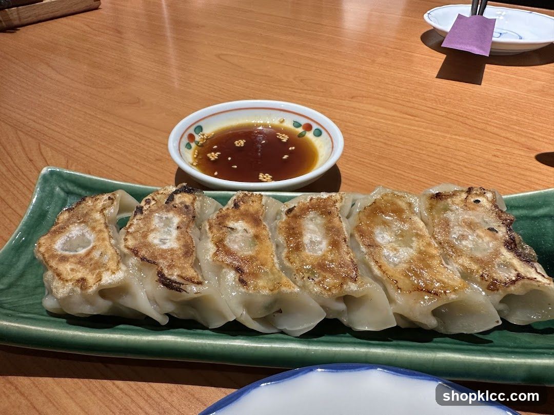 Pan-fried dumplings with dipping sauce