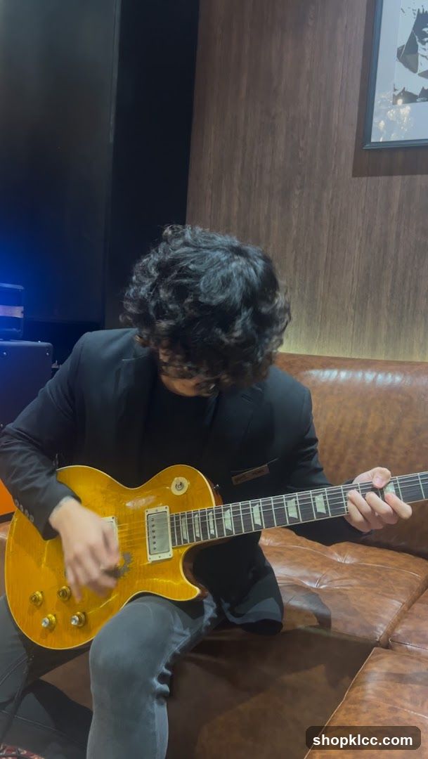 Man playing guitar on couch