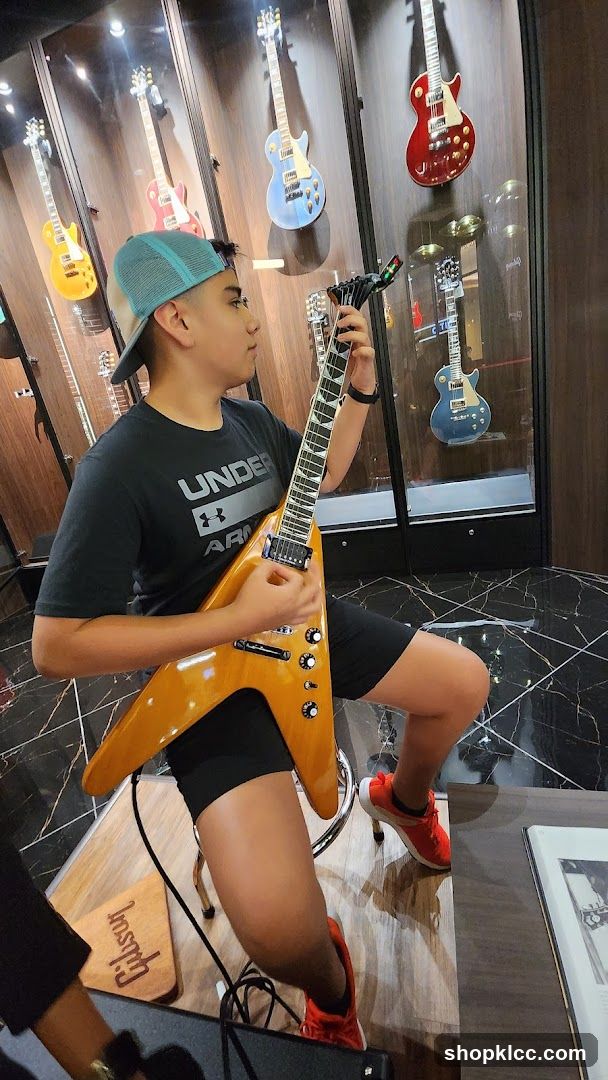 Young person playing a guitar