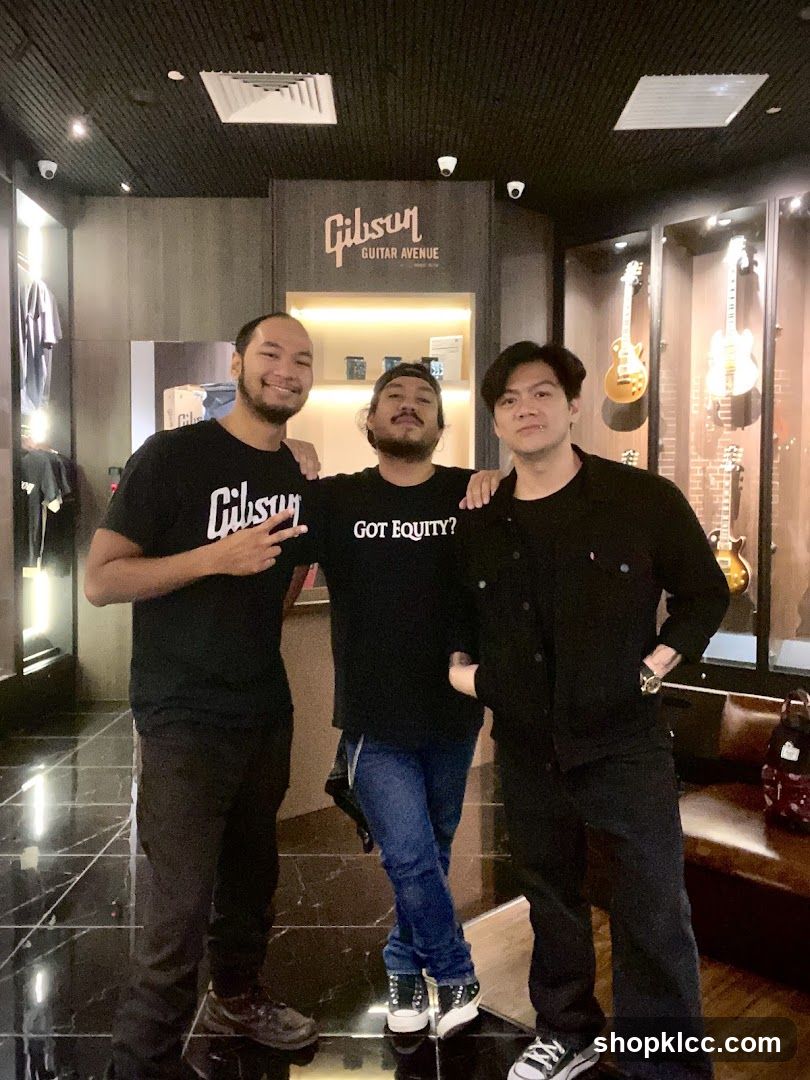 Three men posing in a guitar store
