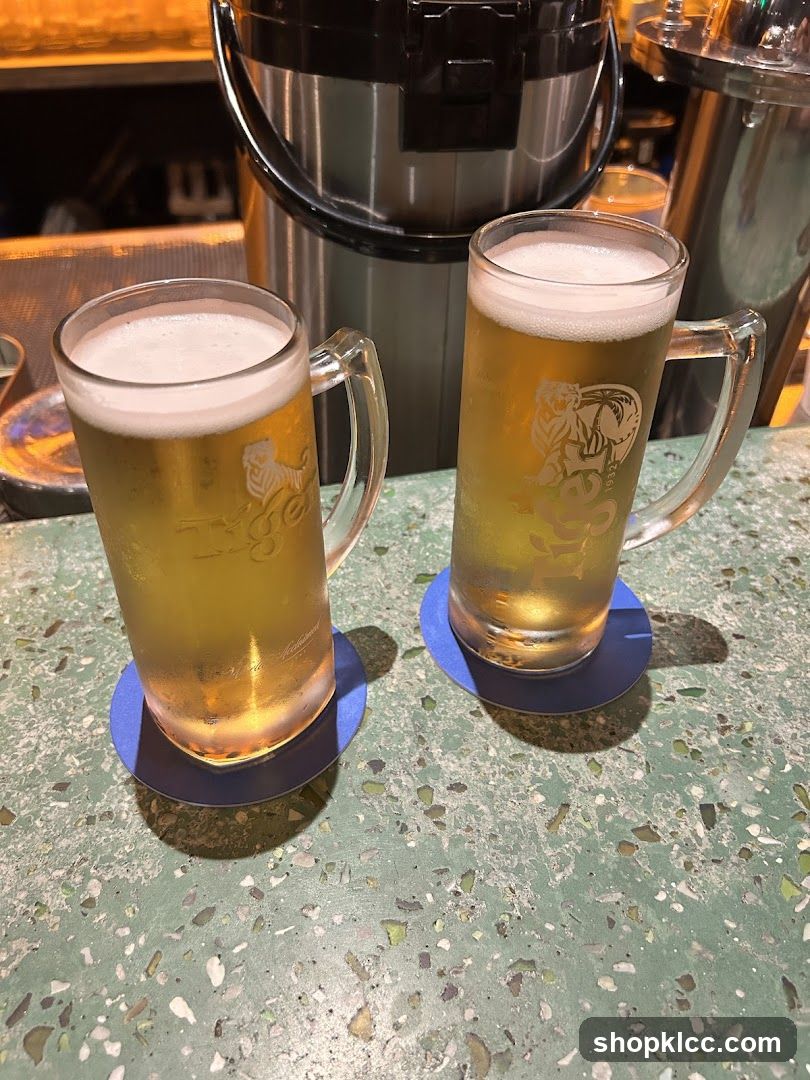 Two mugs of beer on a counter