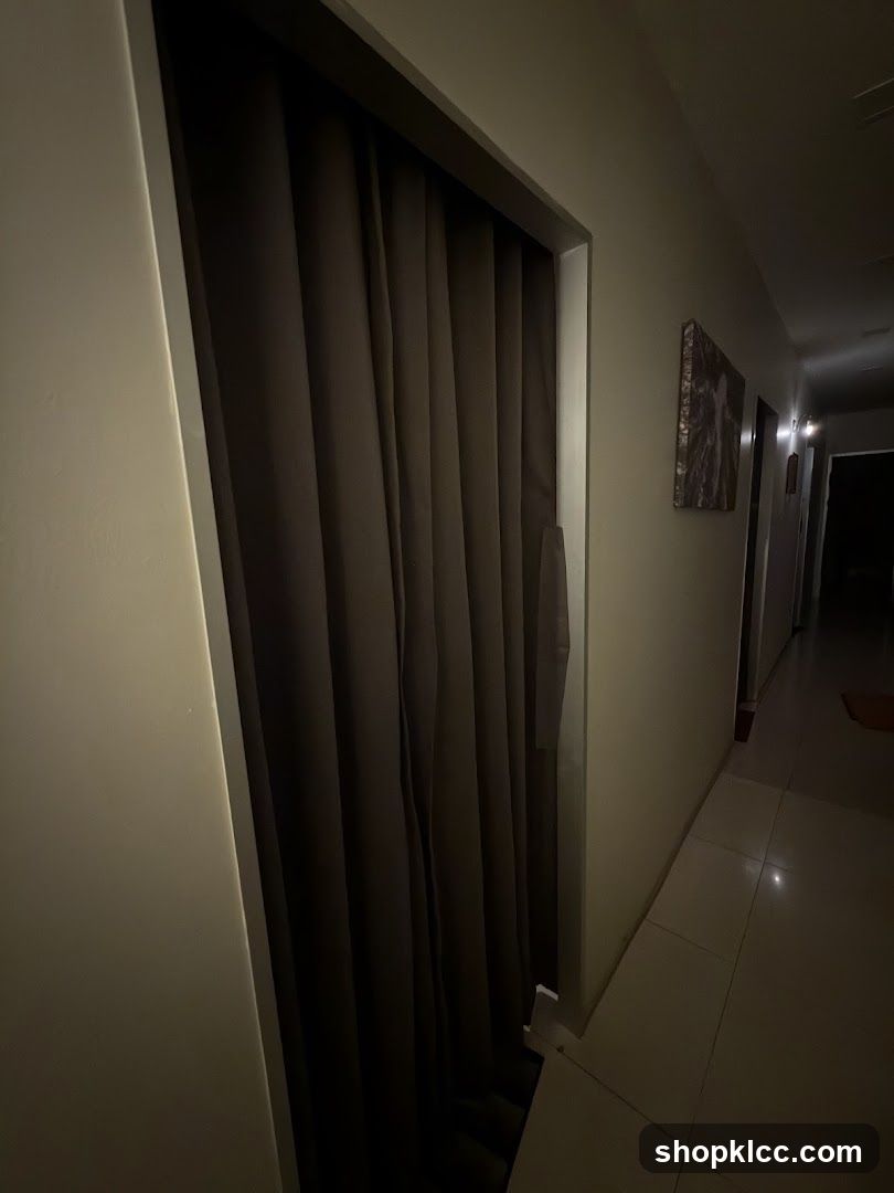 Dimly lit hallway with closed door