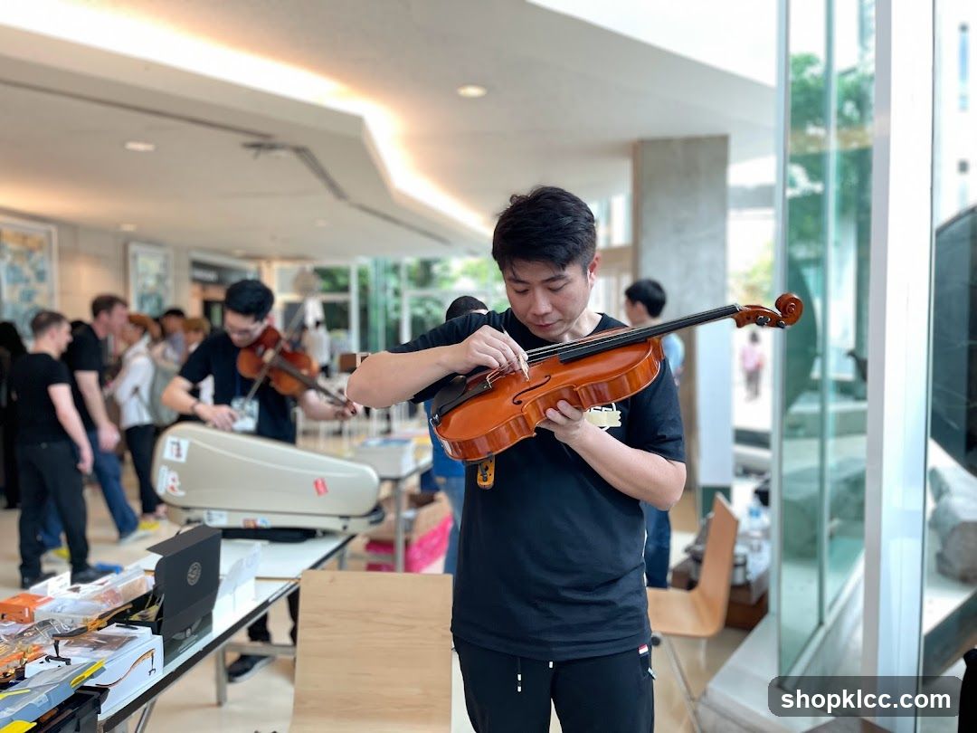 Man Adjusting Violin Strings