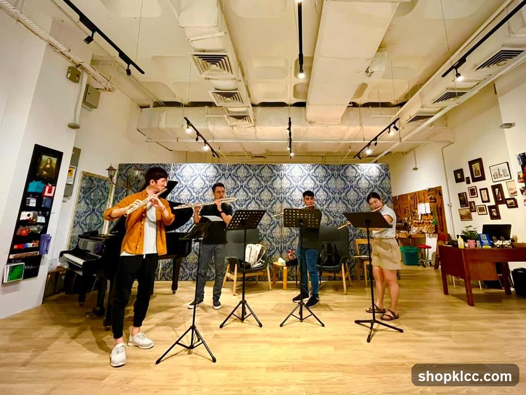 Four people playing flutes in a room
