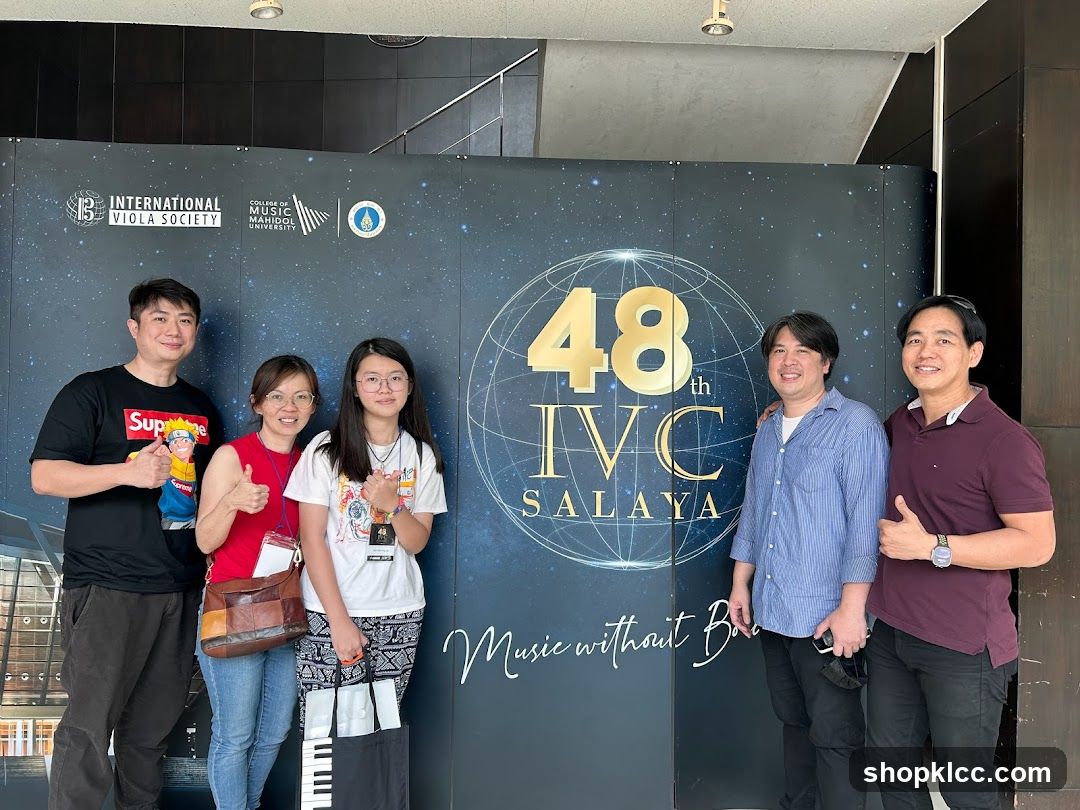 Group Poses in Front of Event Banner