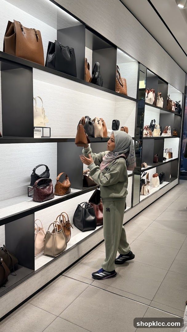 Woman Browsing Handbags in Store