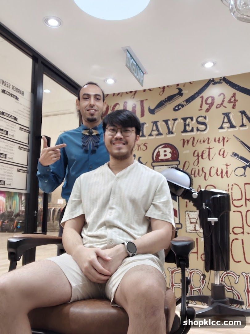 Barber Shop Interior with Staff and Customer