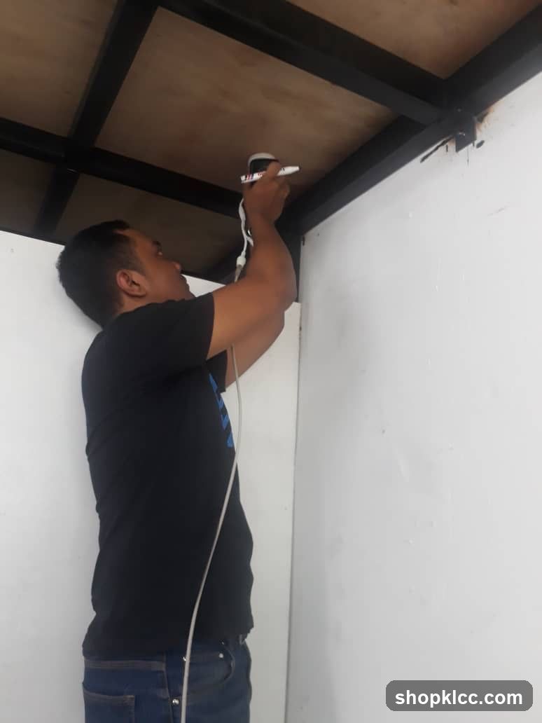 Worker Installing Ceiling Fixture