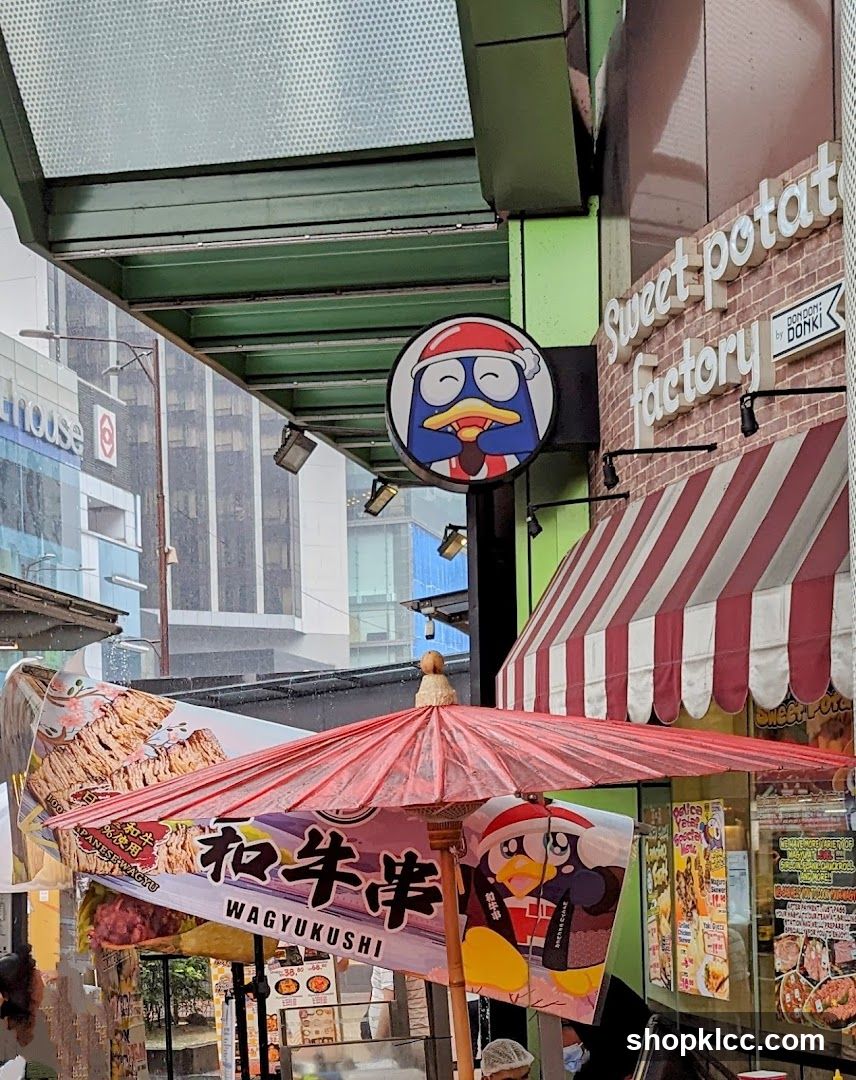 Street Food Scene with Red Umbrella and Shop Signage