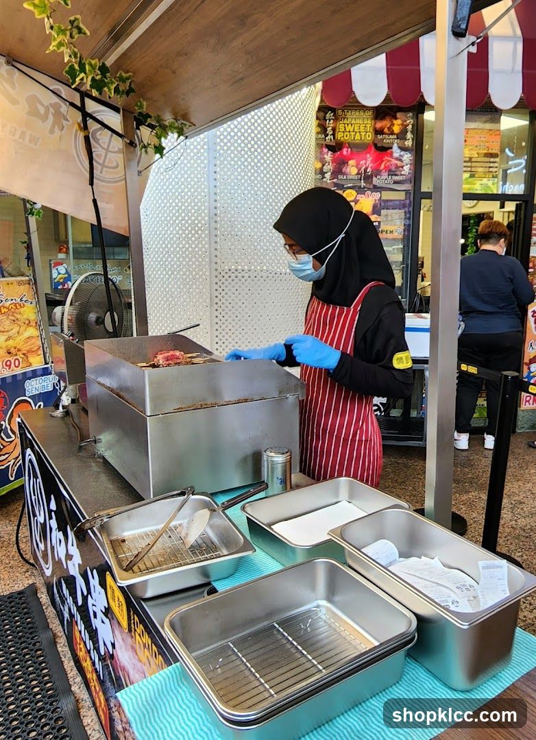 Food Stall with Staff Preparing Food