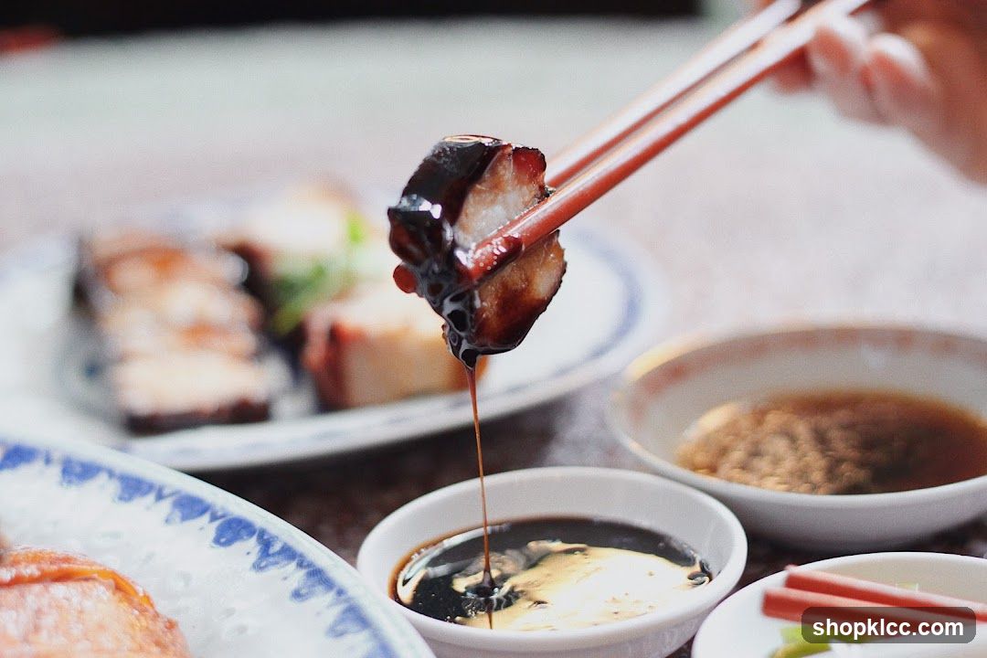 Dipping Roasted Pork Belly in Sauce