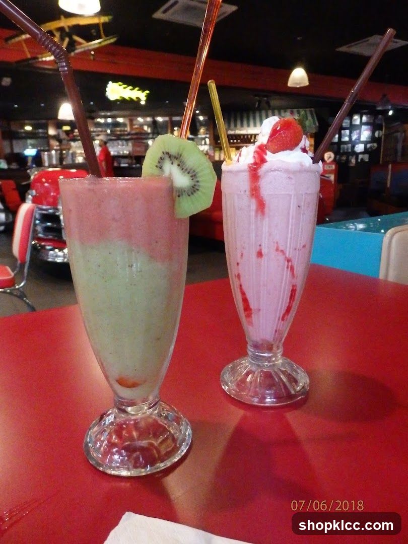 Two milkshakes on a red table