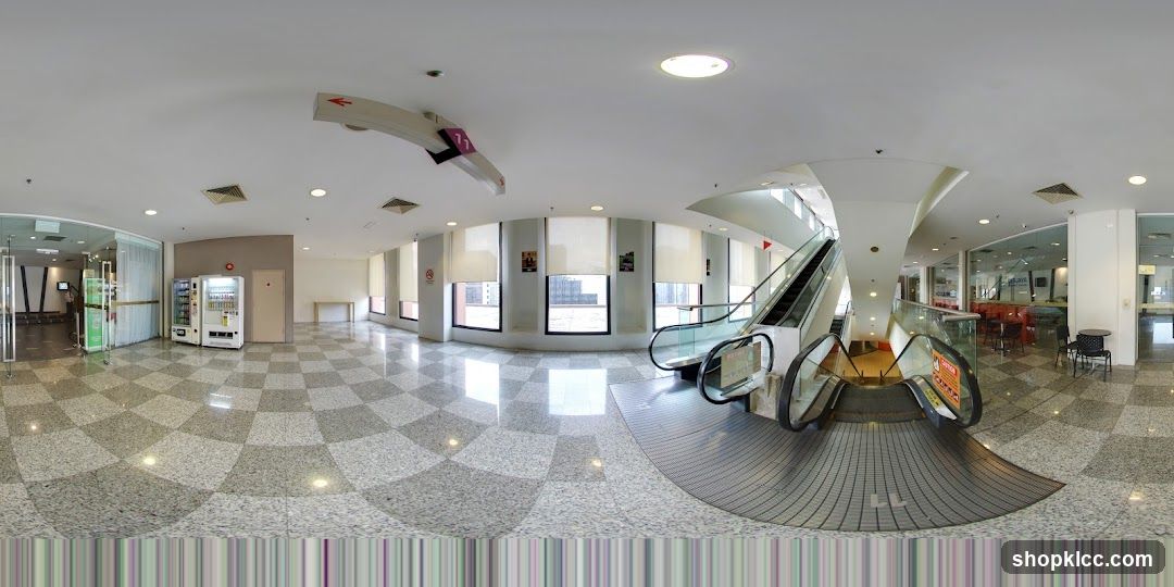Interior of a modern building with escalators and vending machines
