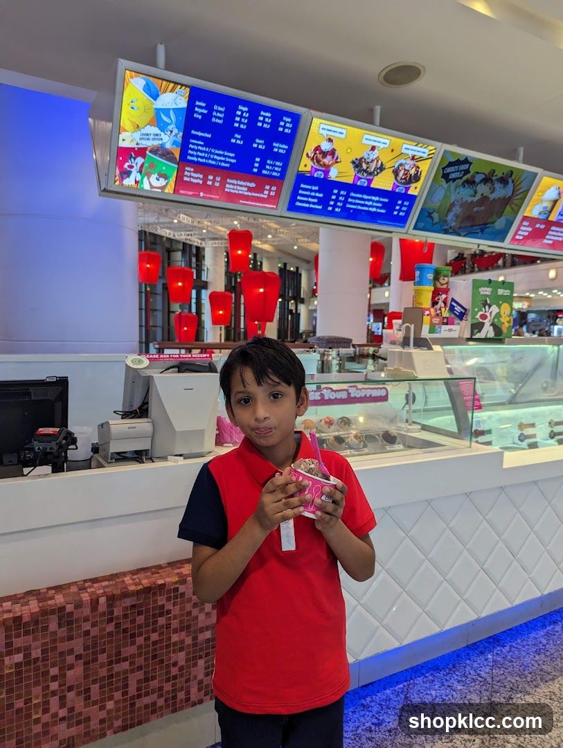 Boy holding ice cream in mall food court
