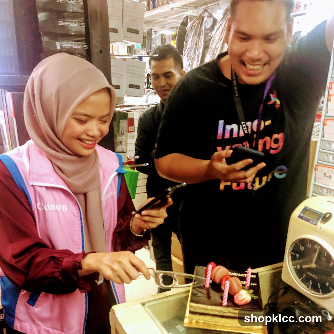 Staff cutting cake in store