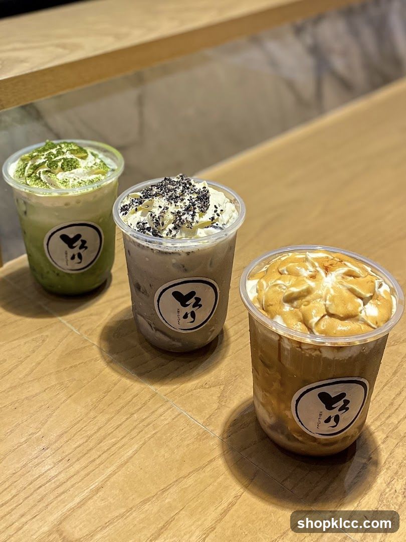 Three Matcha and Latte Drinks on a Wooden Table