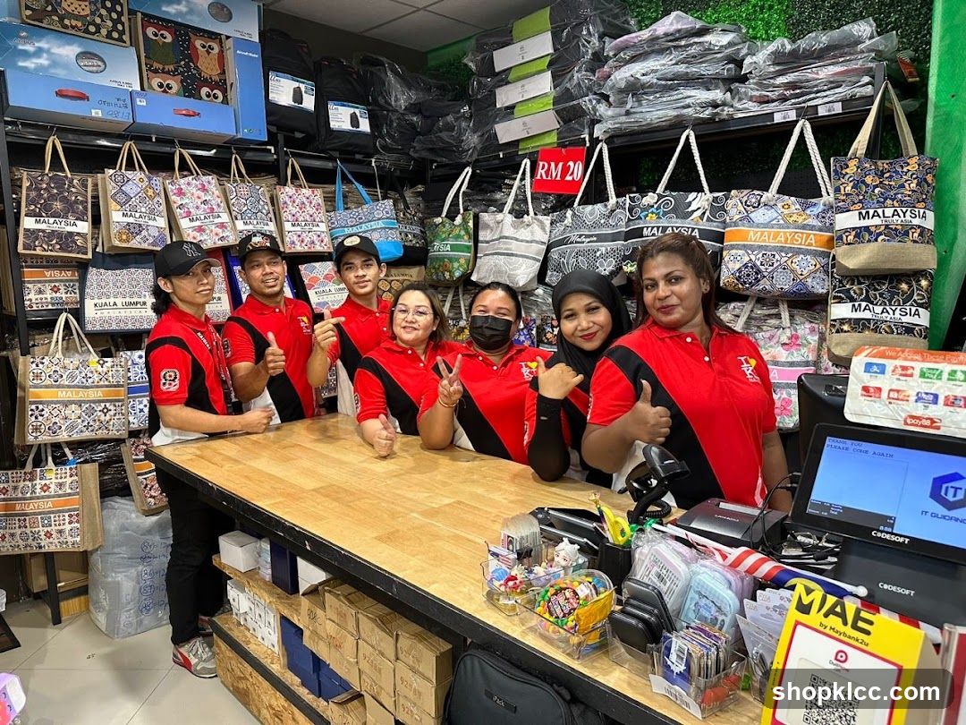 Staff in Red and Black Shirts at Counter