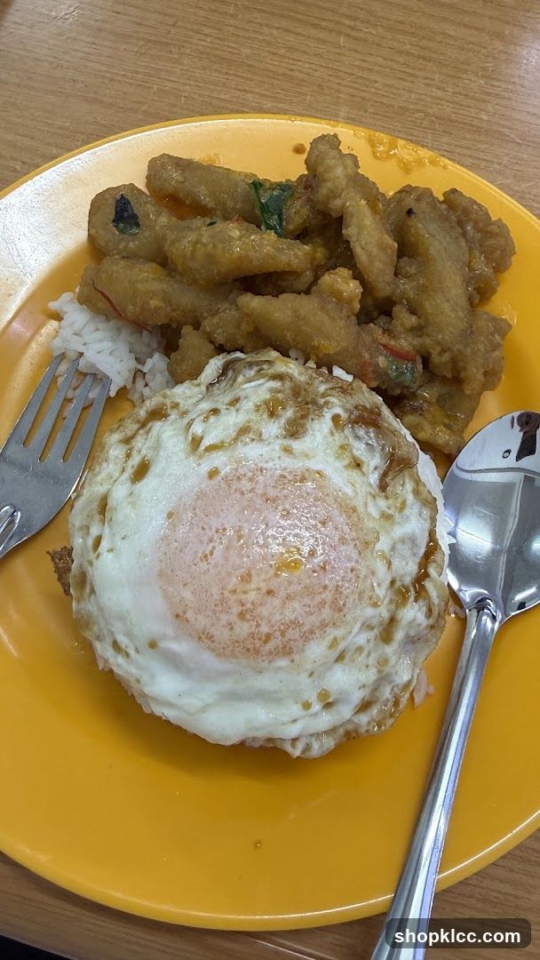 Fried Egg and Curry Dish on Yellow Plate