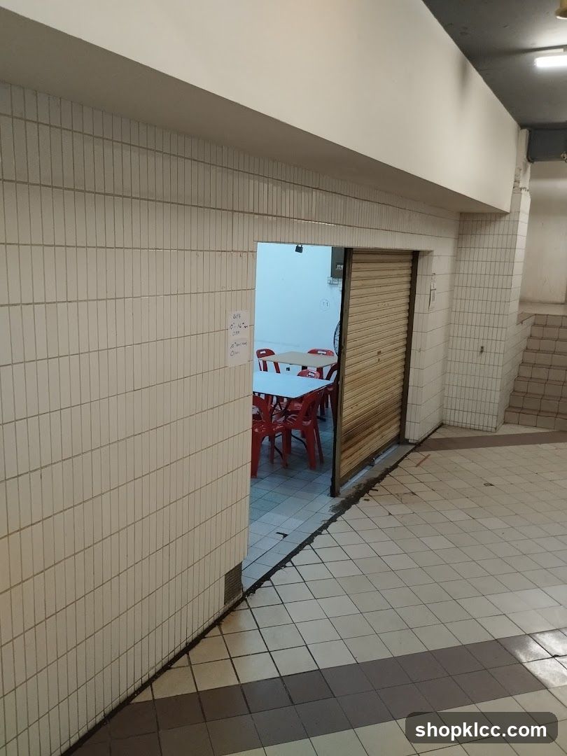 Tiled Corridor with Partially Open Shop Entrance