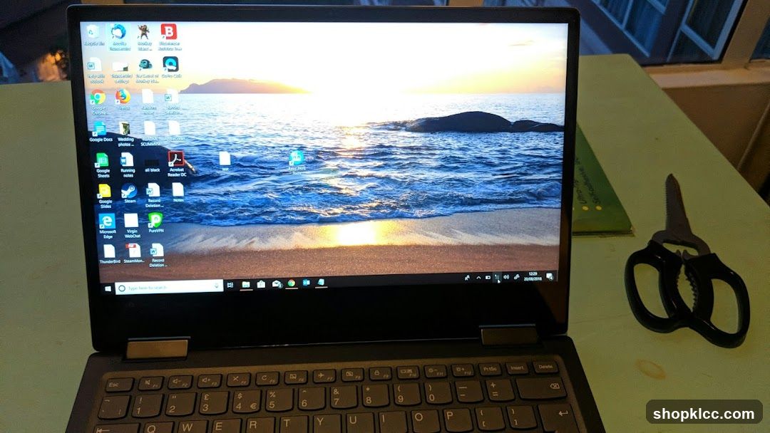 Laptop on desk with scissors nearby