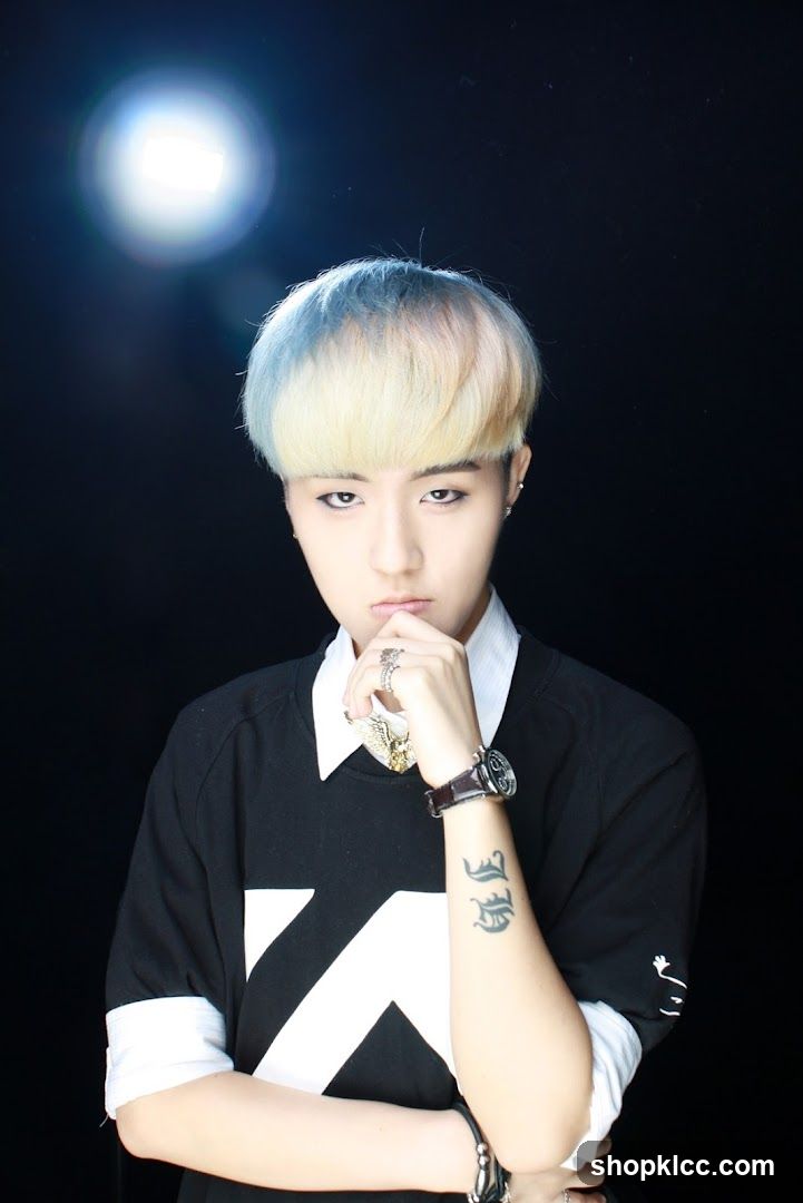 Portrait of a person with bleached hair and black shirt
