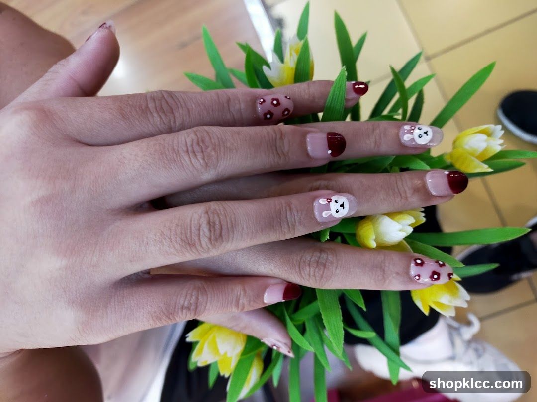 Hand with Cute Nail Art and Flowers