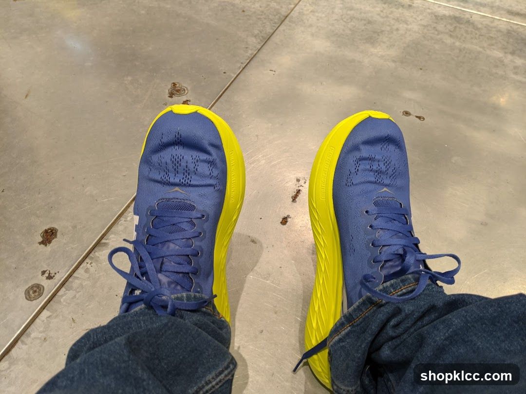 Blue and Yellow Sneakers on Concrete Floor
