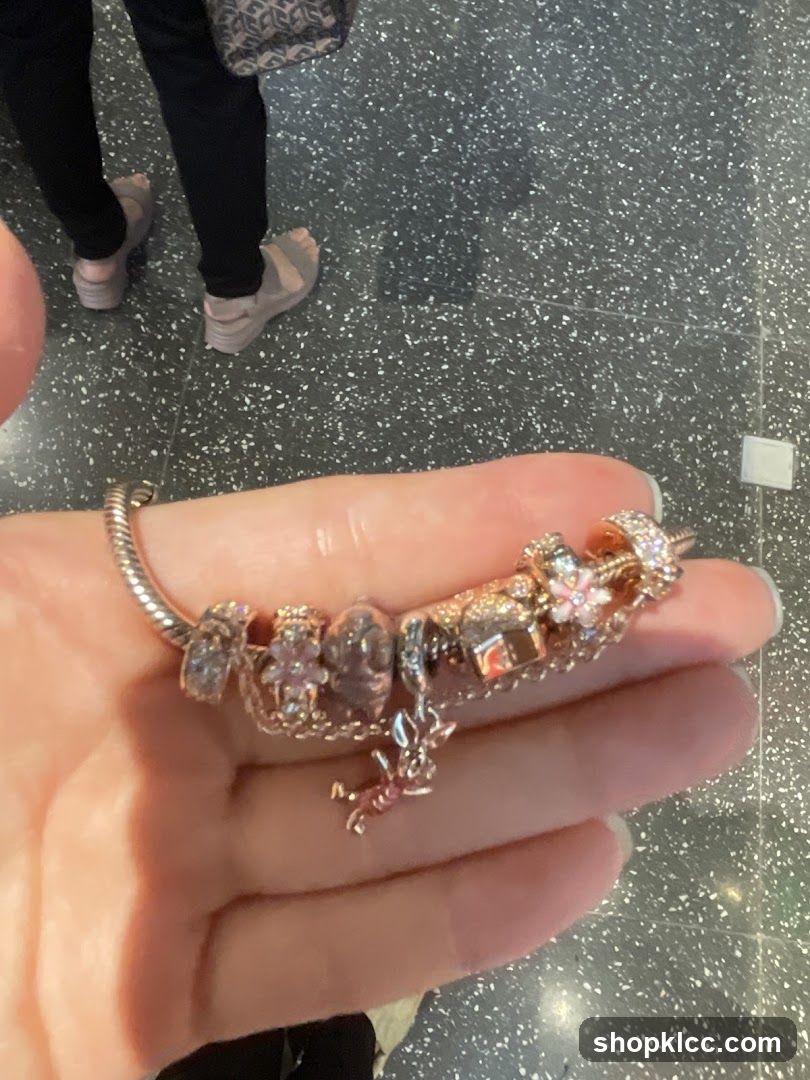 Hand holding Pandora charm bracelet
