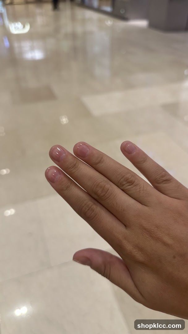 Hand with polished nails in a mall or lobby