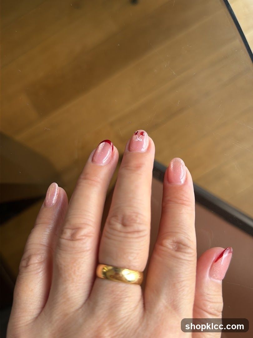 Hand with Pink Nail Art and Gold Ring