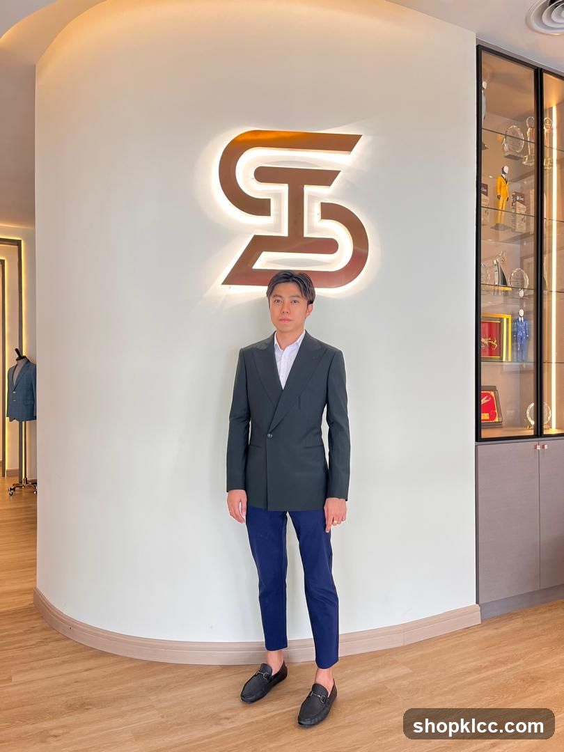 Man Posing in Front of a Logo