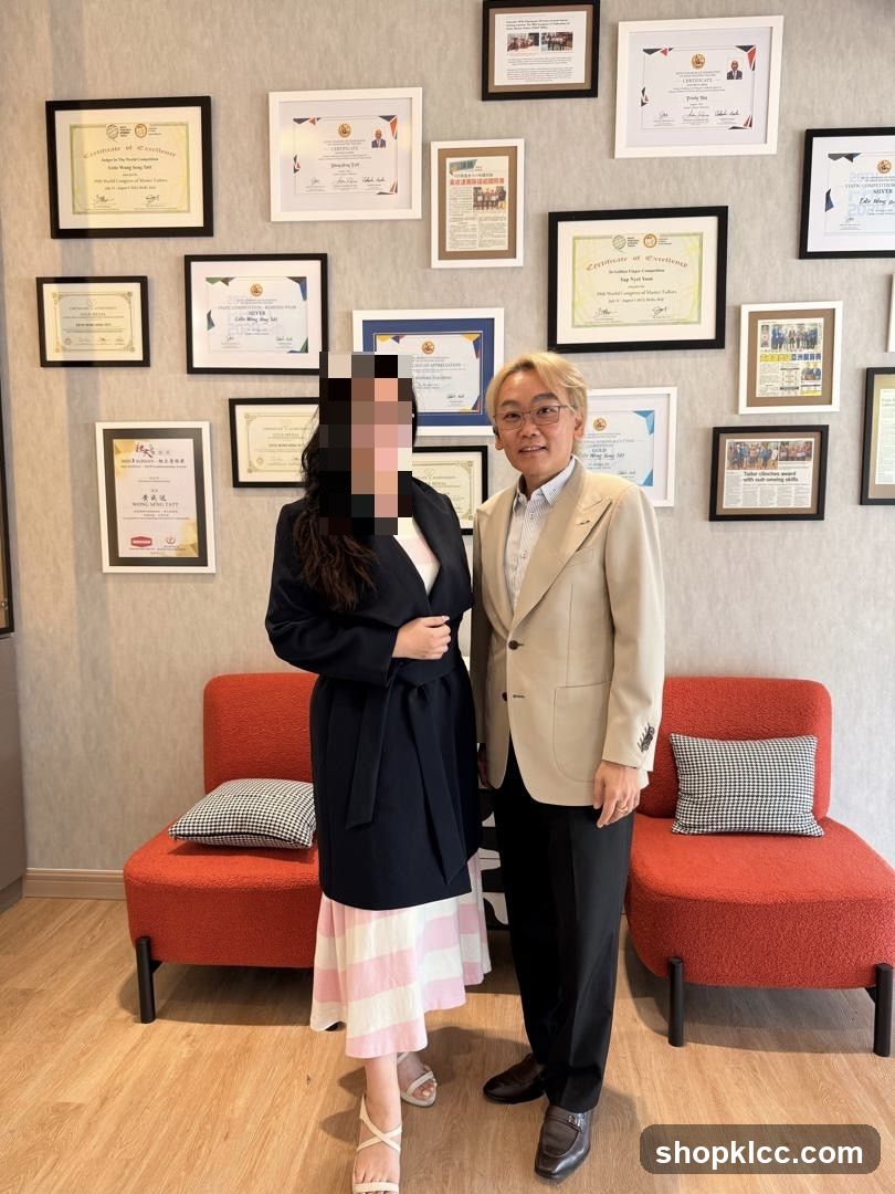 Two people standing in front of framed certificates