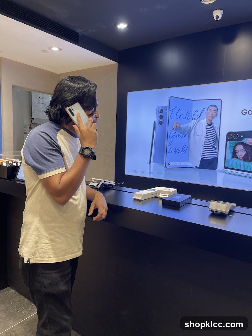 Man on Phone in Electronics Store