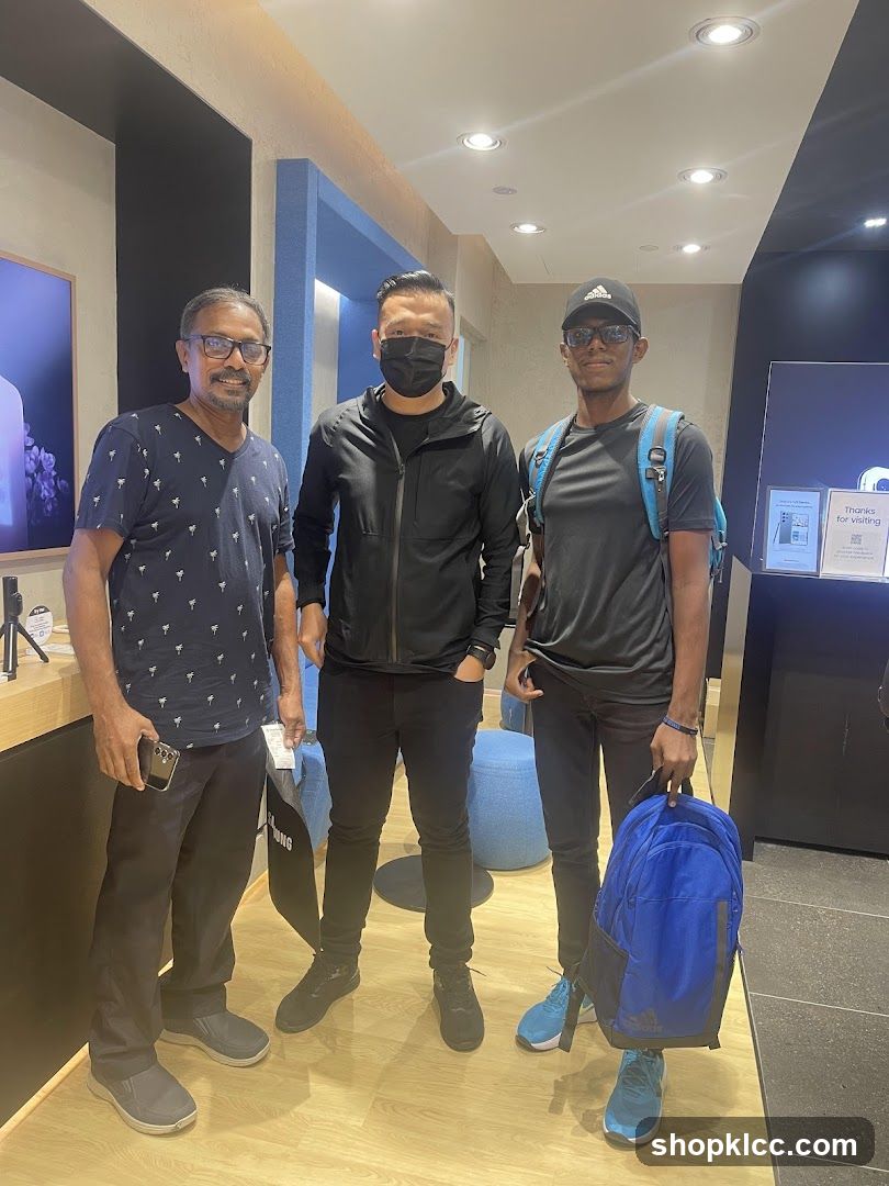Three men posing for a photo inside a store