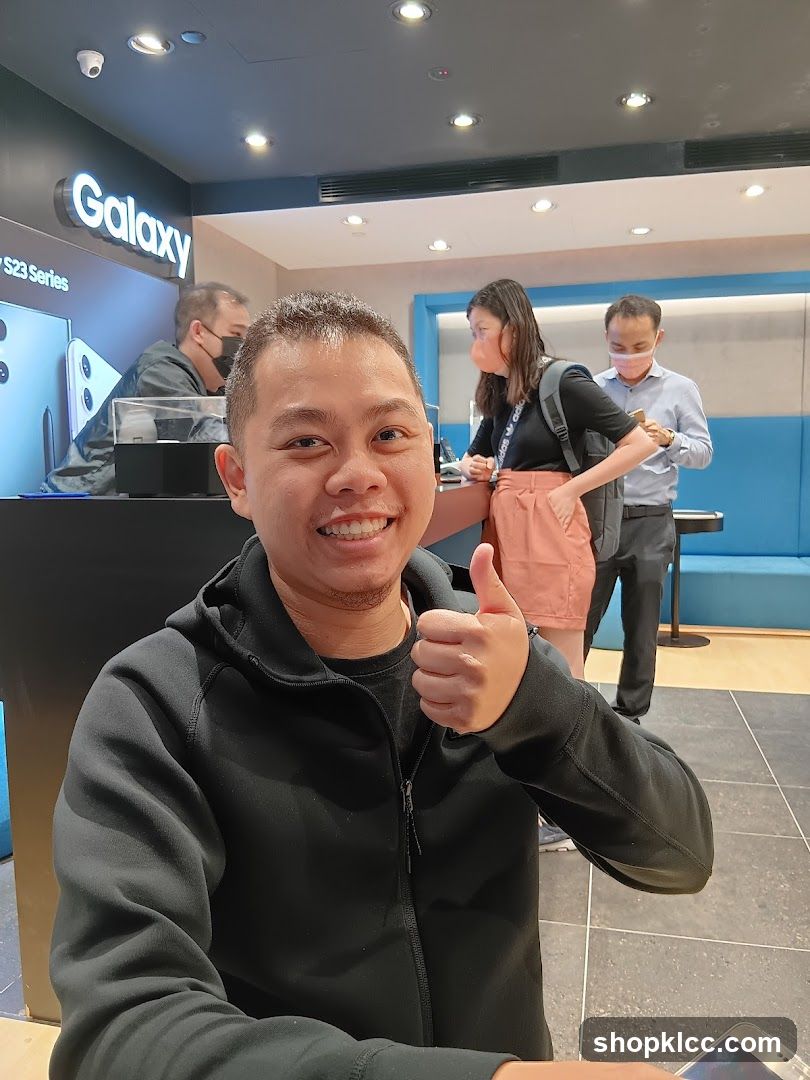 Man giving a thumbs up in a store
