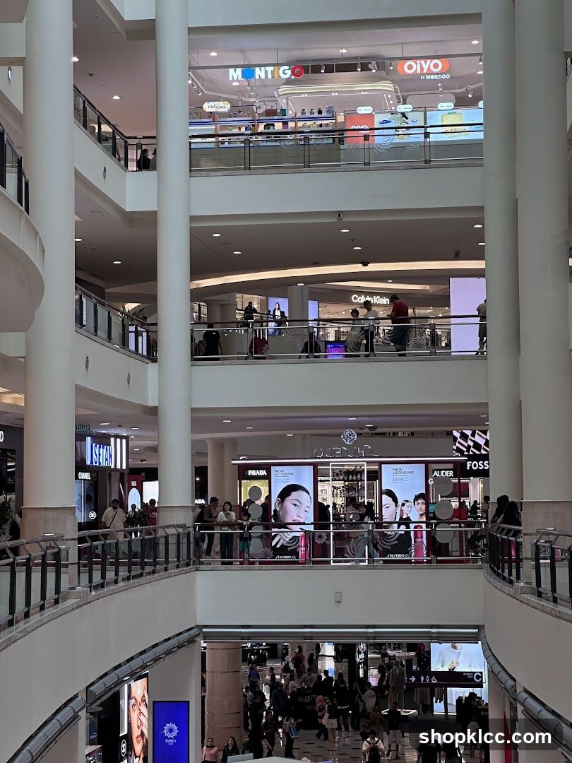 Multi-level shopping mall interior with various stores